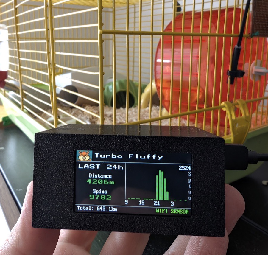 The Collidera sensor and display fitted to a hamster wheel beside the cage